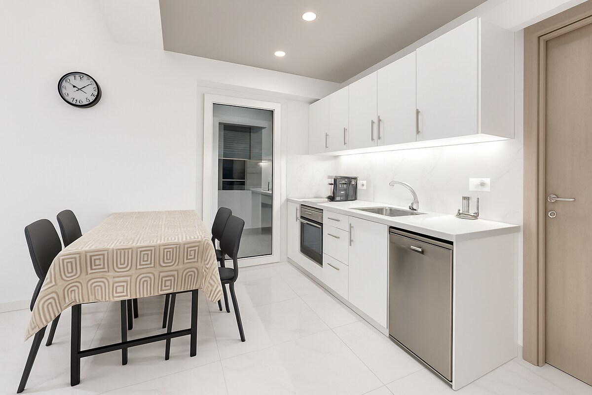 Dining table and adjacent fully-equipped kitchen